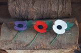 Purple, Red and White needle felted poppies on a rustic wooden log for armistice day